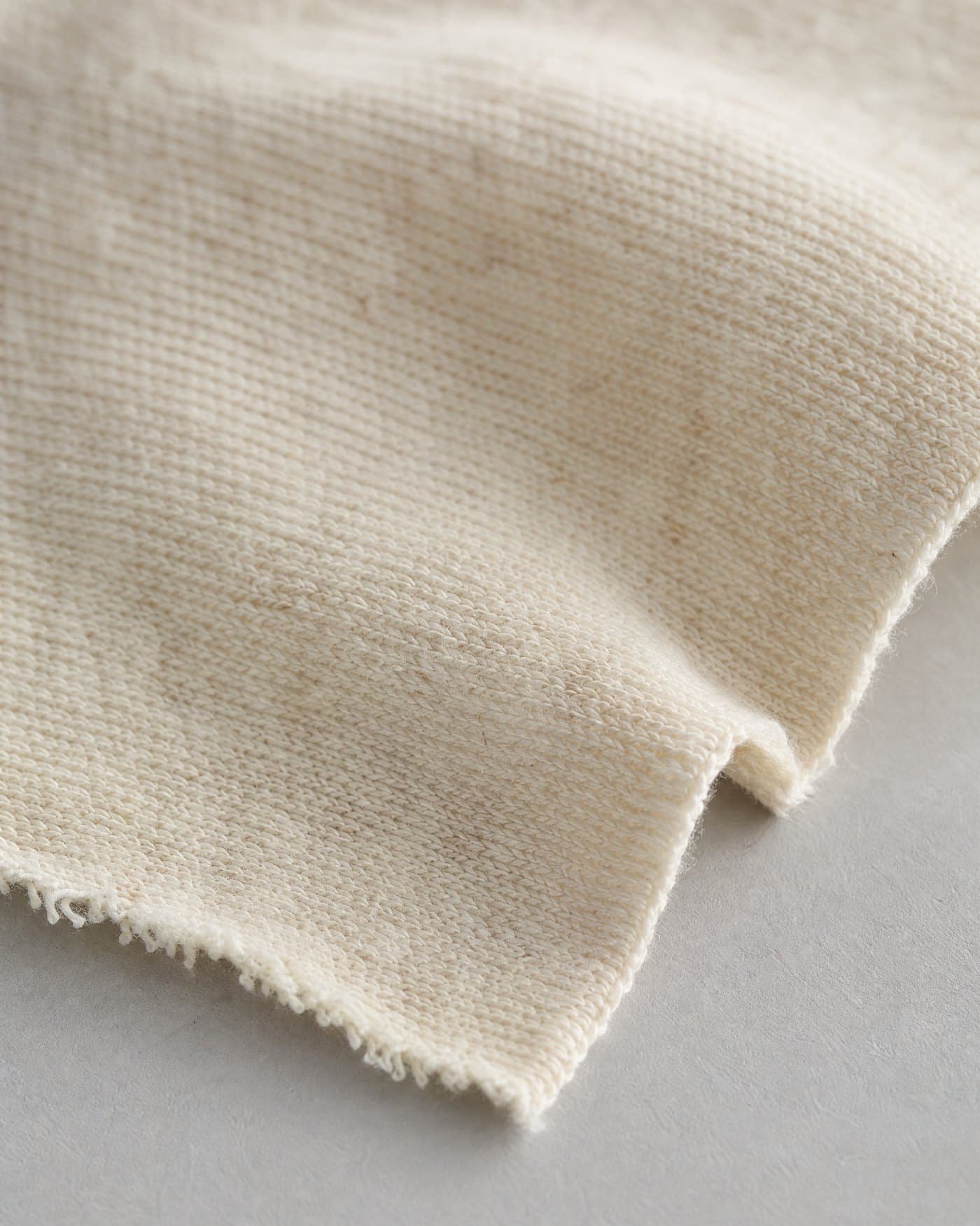 A swatch of undyed ecru organic cotton single jersey