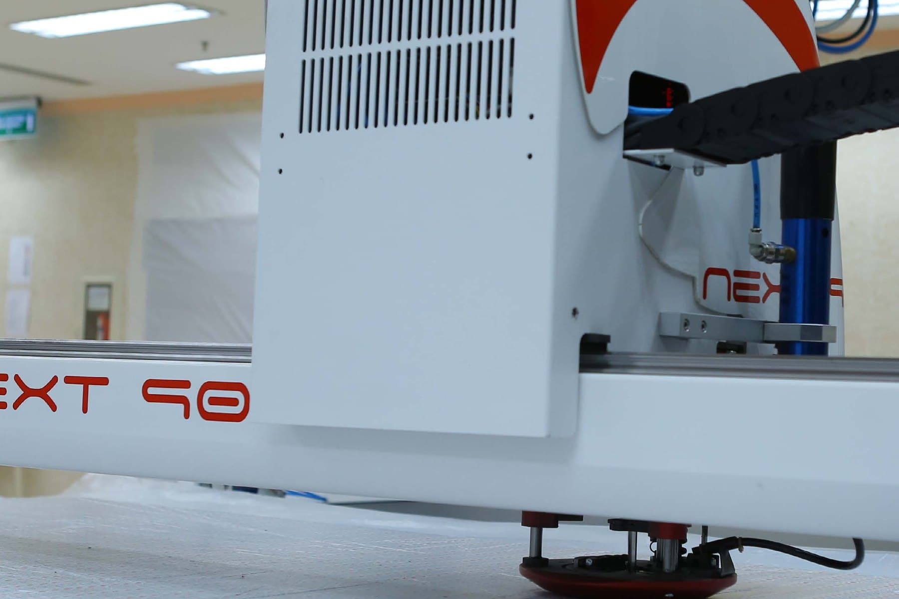 An automated cutting machine working through a spread lay of fabric