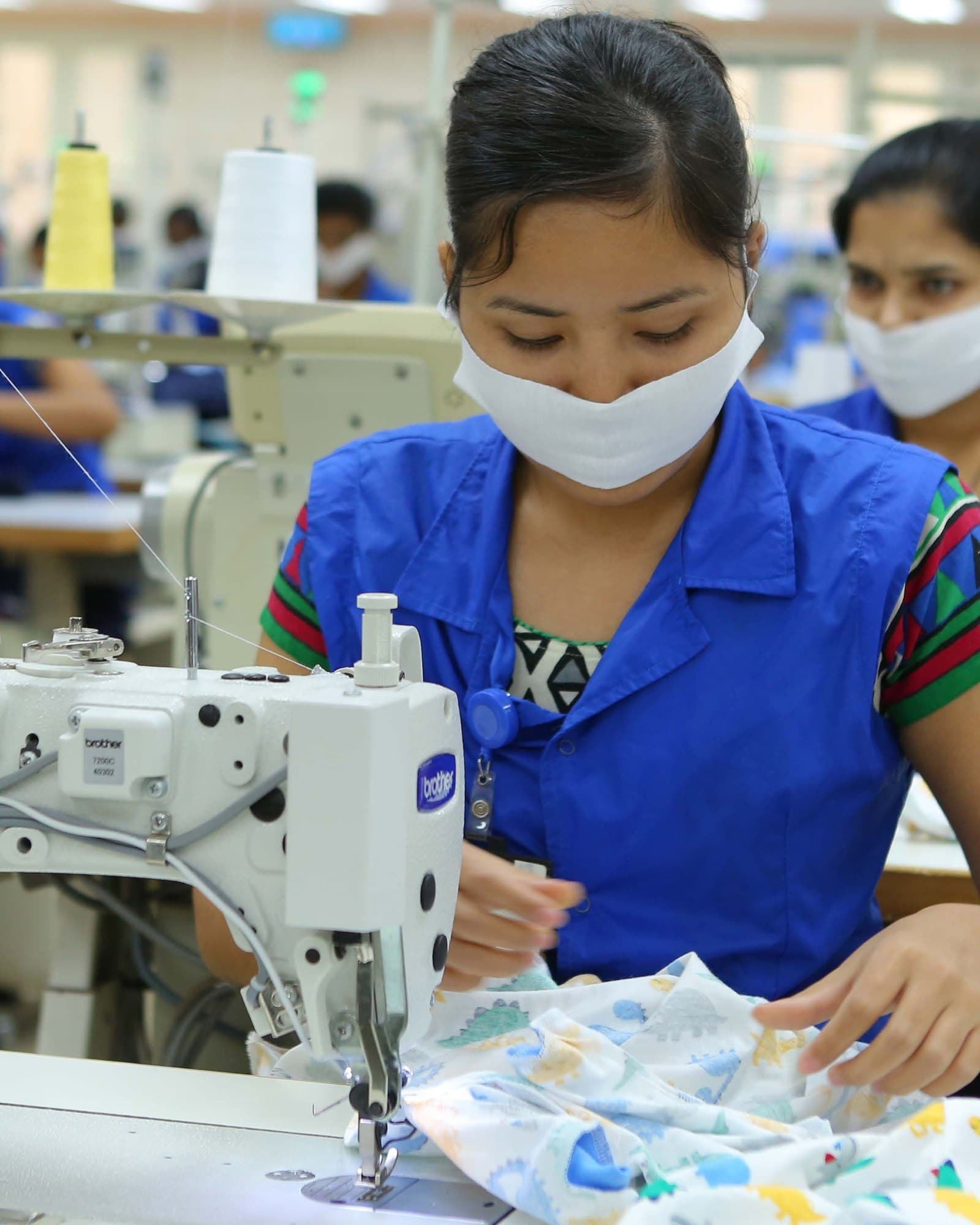 An operator sewing printed fabric for infant garments